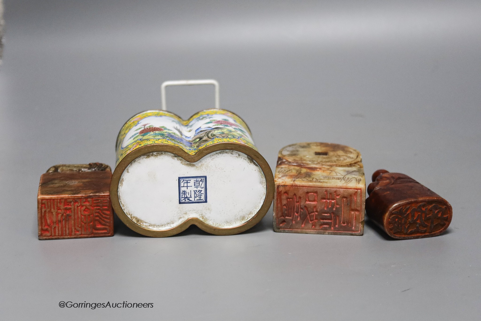 A Chinese enamel on copper brush pot together with three soapstone seals, 10cm